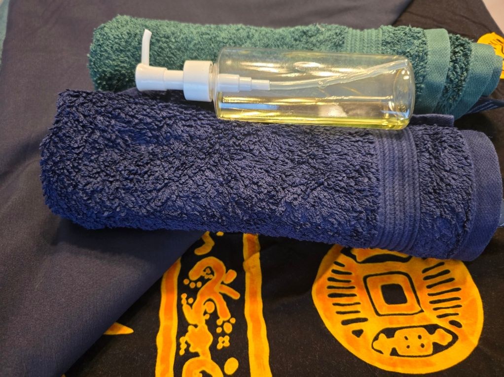 Massage oil and towels ready for a Serenity Swedish Massage appointment
