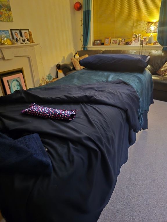 Calm treatment room with massage table and soft lighting