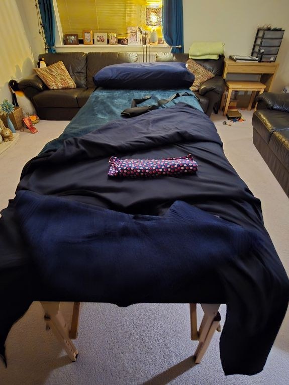 Massage table prepared in a calm home treatment space